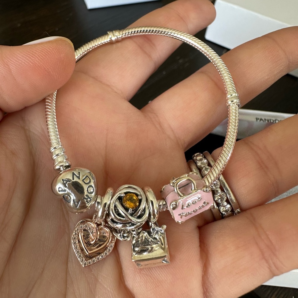 BNIB Pandora sterling silver bracelet with lots of charms